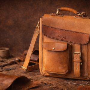 Full-grain leather messenger bag with brass hardware, artisan leather craftsmanship