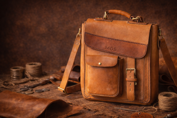 Full-grain leather messenger bag with brass hardware, artisan leather craftsmanship